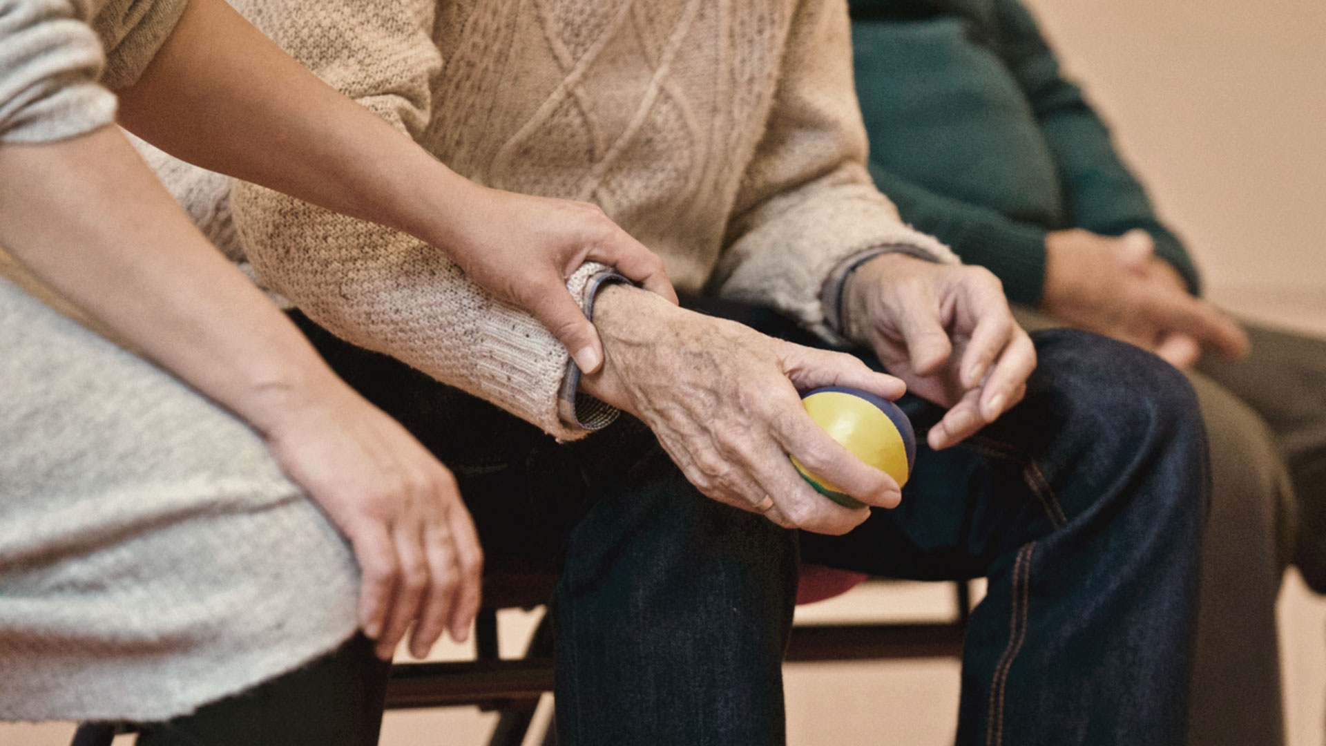 Elderly person holding a ball
