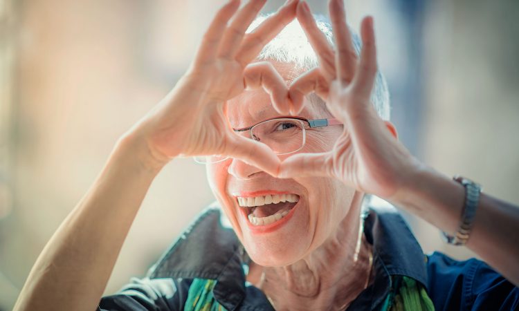 Femme âgé qui fait un coeur avec ces mains