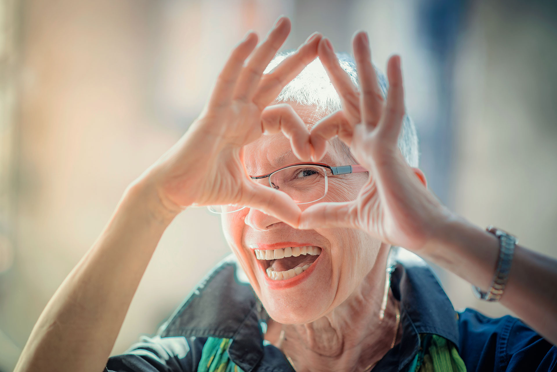 Elderly woman making a heart with her hands