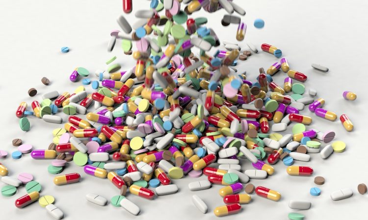 Several different drugs falling on a table